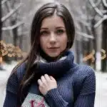 A young woman, looking a little stressed, holding a Christmas present, winter street background