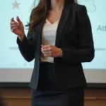 A formally dressed young woman doing a presentation