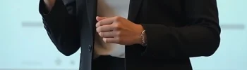 A formally dressed young woman doing a presentation