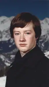 AI-generated image resembling Tom in 1981, standing in front of snowy mountains