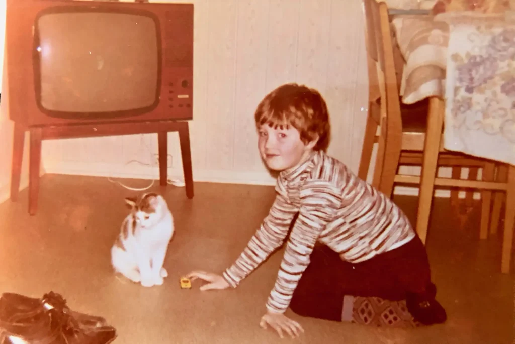 Tom as a boy with a cat, approximately 1973